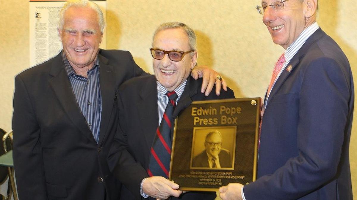 Retired Miami Dolphins Coach Don Shula, Edwin Pope and team owner Stephen Ross with the plaque naming the press box after Pope on Nov. 14, 2010.