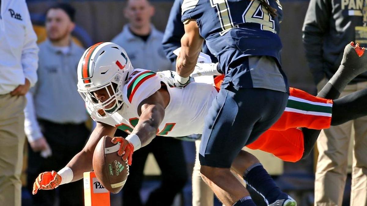 Miami Hurricanes Ahmmon Richards (82) dives for a second quarter touchdown as Pitt Panthers Avonte Maddox (14) fails to defend at Heinz Field in Pittsburgh, Pa, November 24, 2017.
