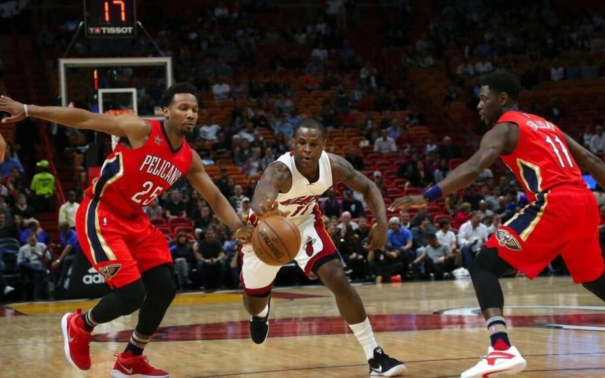 Miami Heat guard Dion Waiters battle for a lose ball against New Orleans Pelicans guard Wayne Selden Jr. (25) and guard Jrue Holiday(11) during the first quarter of an NBA basketball game at AmericanAirlines Arena in Miami on Wed., March 15, 2017.
