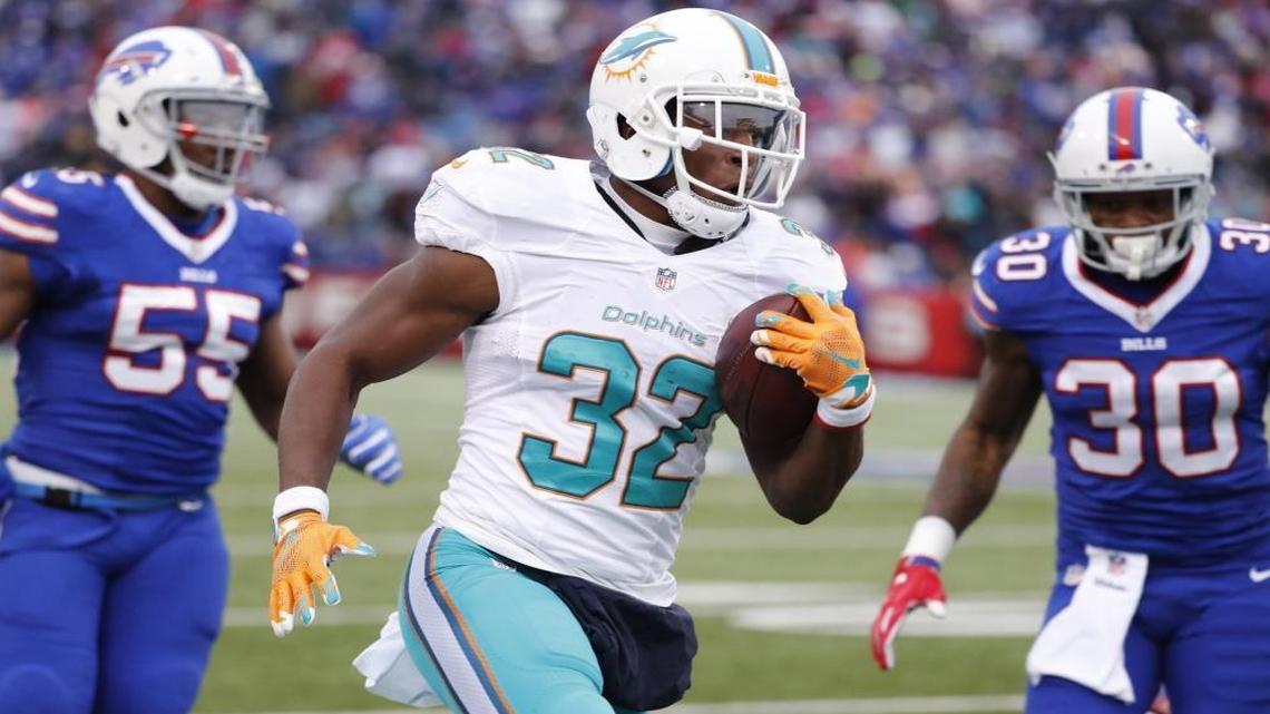 Miami Dolphins running back Kenyan Drake (32) runs in to score in the second quarter as the Buffalo Bills host the Miami Dolphins at New Era Field in Orchard Park, NY on Sat, Dec. 24, 2016.