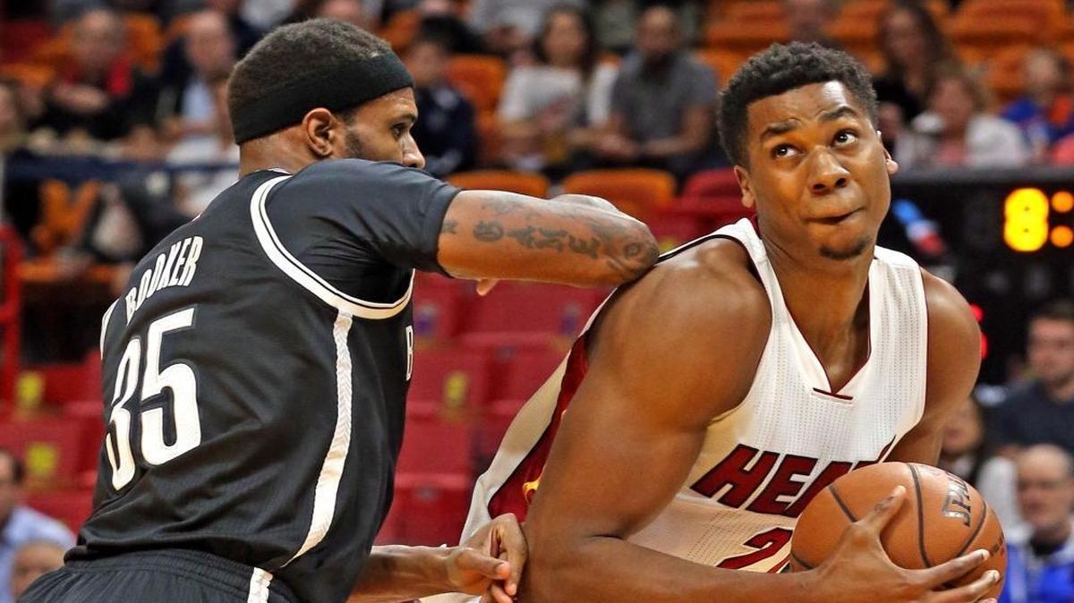Miami Heat Hassan Whiteside gets pushed from the back by Brooklyn Nets Trevor Booker in the first quarter at the AmericanAirlines Arena in Miami, Florida, Jan. 30, 2017.