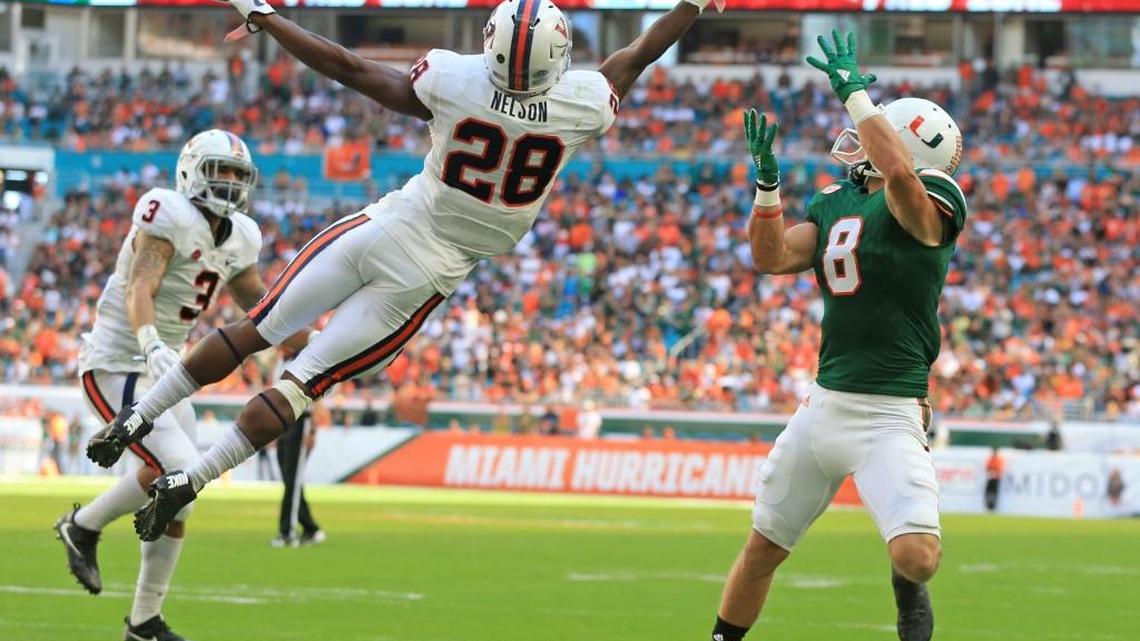 Virginia Cavaliers safety Brenton Nelson (28) deflects an end zone pass intended for Miami Hurricanes wide receiver Braxton Berrios (8) in the first quarter as the University of Miami Hurricanes host the Virginia Cavaliers at Hard Rock Stadium on Saturday, November 18, 2017.