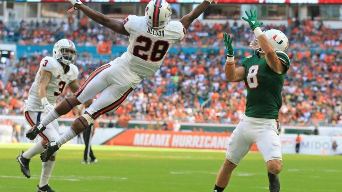 Virginia Cavaliers safety Brenton Nelson (28) deflects an end zone pass intended for Miami Hurricanes wide receiver Braxton Berrios (8) in the first quarter as the University of Miami Hurricanes host the Virginia Cavaliers at Hard Rock Stadium on Saturday, November 18, 2017.