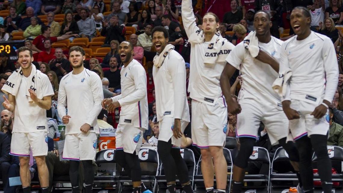 Miami Heat players react after Udonis Haslem (40) blocked Washington Wizards' Kelly Oubre Jr. (12) from scoring in the fourth quarter in a game last month. The Heat needs one more win or one Detroit loss to clinch a playoff berth.