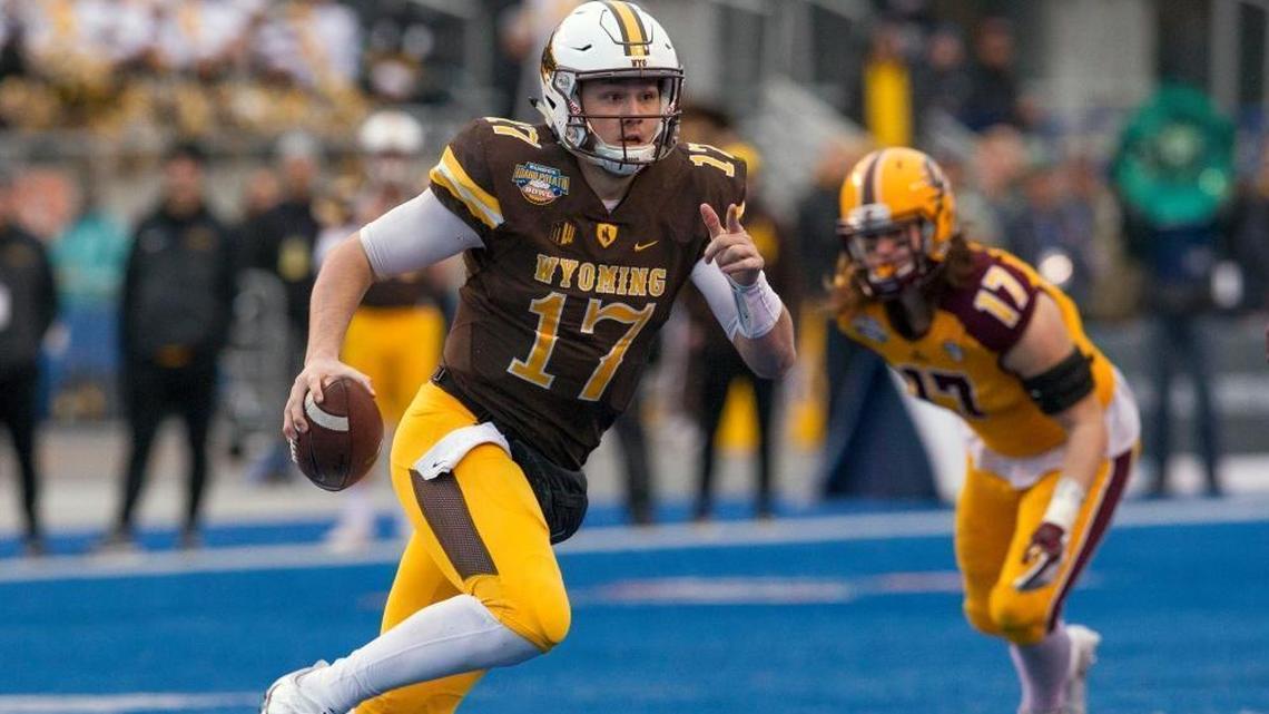 Wyoming quarterback Josh Allen (17) runs with the ball against Central Michigan during the Famous Idaho Potato Bowl last December. Allen will visit the Dolphins this week. (Darin Oswald/Idaho Statesman via AP)