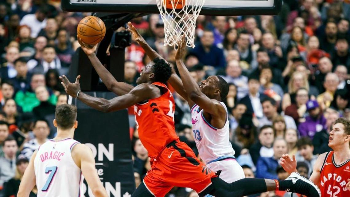 Toronto Raptors' Pascal Siakam, left, goes to the basket against Miami Heat center Bam Adebayo during Tuesday’s game. (Mark Blinch/The Canadian Press via AP)