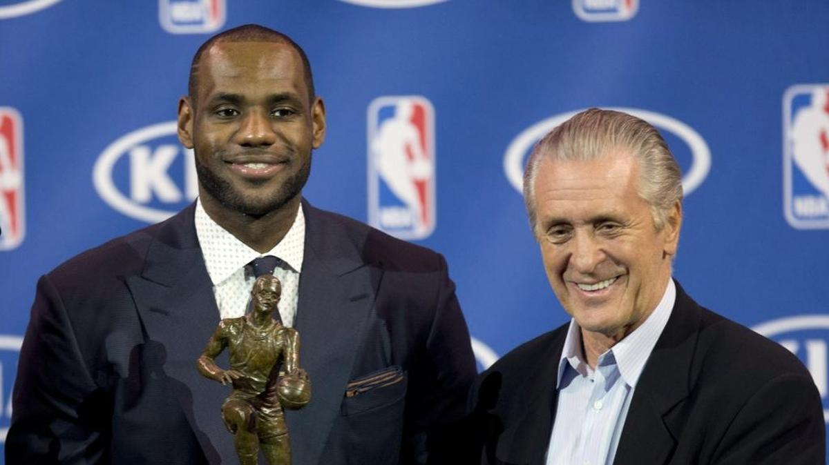 LeBron James holds his NBA Most Valuable Player award as he stands with Miami Heat team president Pat Riley in 2013. The two men haven’t spoken since James left the Heat but showed a sign of respect to each other, according to author Ian Thomson.