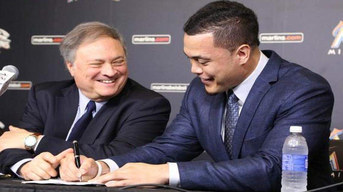 
Marlins owner Jeffrey Loria looks on as outfielder Giancarlo Stanton signs a 13-year, $325 million contract Wednesday, Nov. 19, 2014. 

