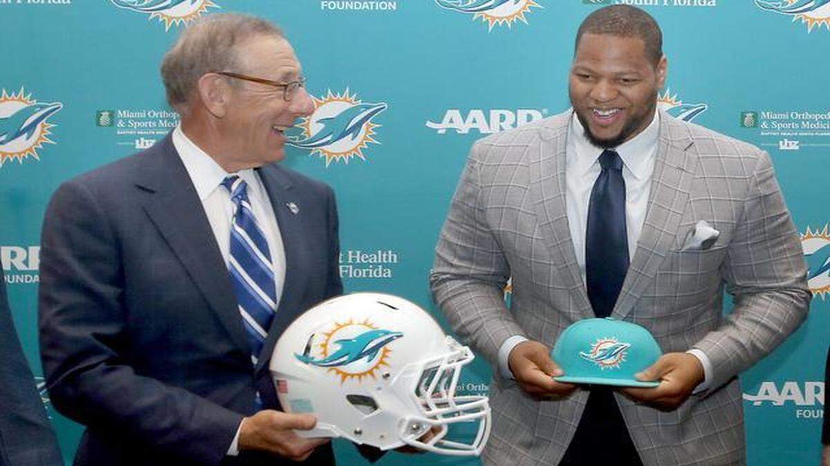 
Miami Dolphins owner Stephen Ross shares a laugh with Ndamukong Suh on Wednesday, March 11, 2015.
