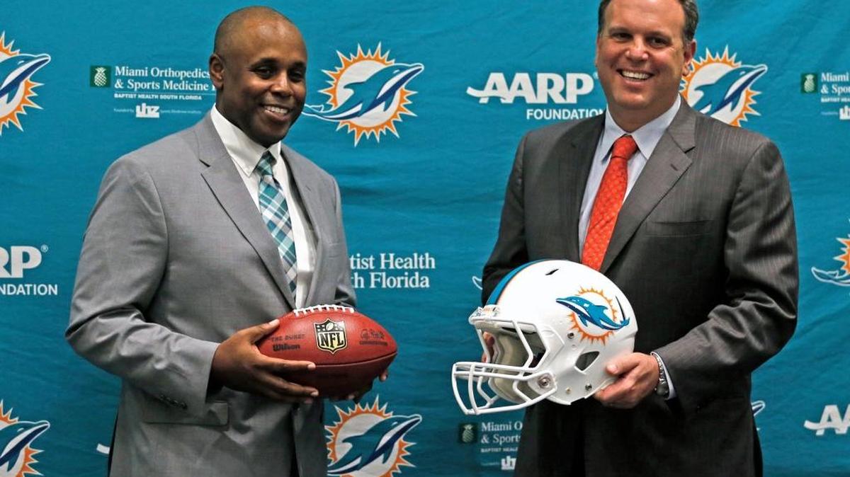 Miami Dolphins new general manager Chris Grier poses with executive vice president of football operations Mike Tannenbaum at the team’s training facility in Davie, Fla., on Monday, Jan. 4, 2016.