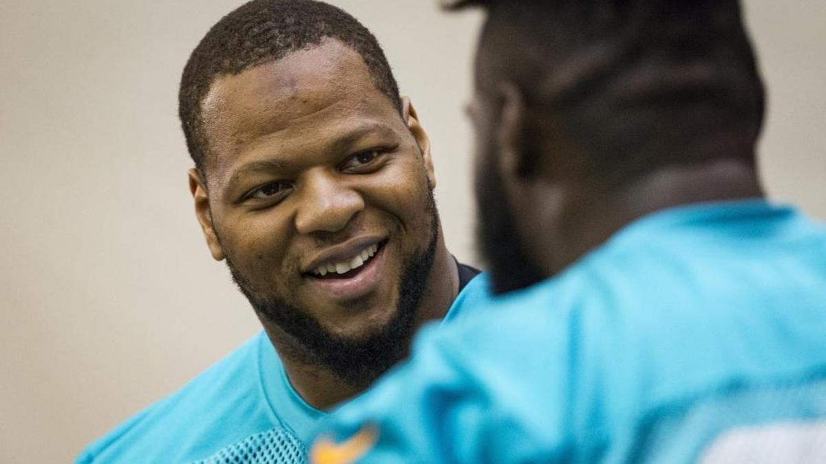 Defensive tackle Ndamukong Suh jokes with a teammate during Miami Dolphins OTAs at Miami Dolphins training facility in Davie.