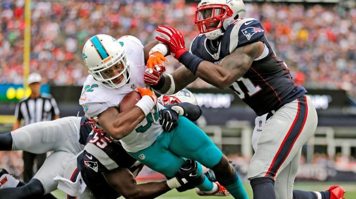 Dolphins running back Kenyan Drake, shown in action vs. Patriots last season, should see an increased role Monday night, but Miami will find Carolina’s defense a tougher challenge than Oakland’s was last week.