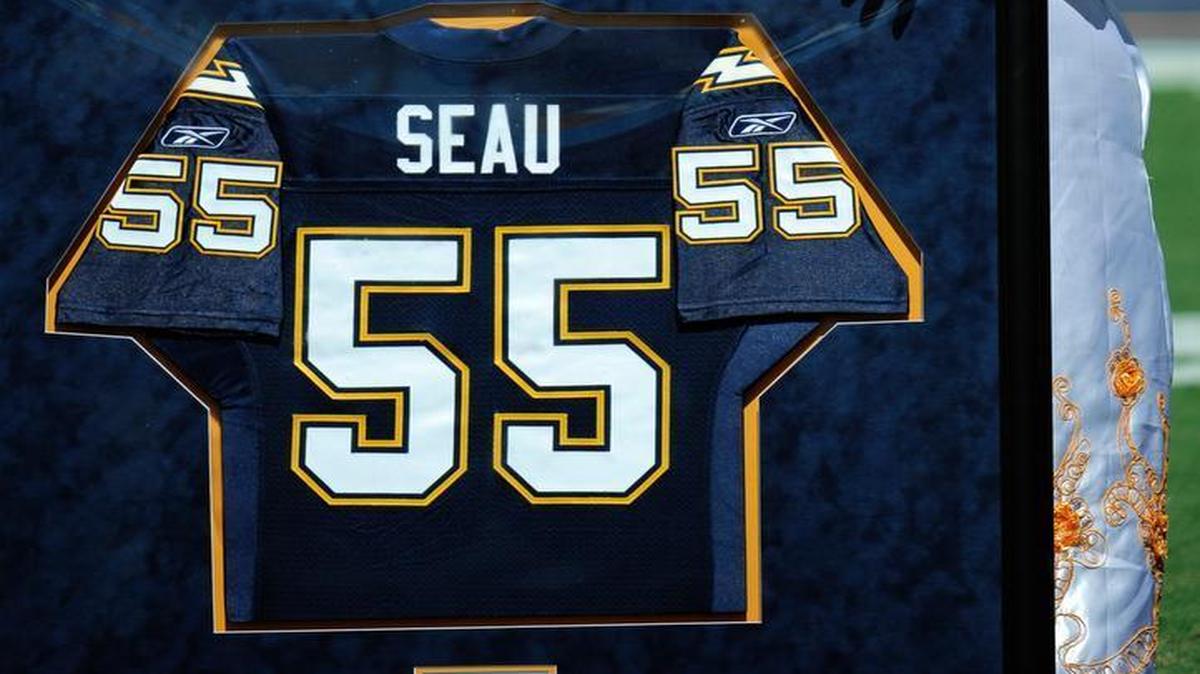 FILE - In this Sept. 16, 2012, file photo, Luisa Seau, right, the mother of former San Diego Chargers linebacker Junior Seau, wipes her eyes during a ceremony to retire Seau's No. 55 uniform before the Chargers play the Tennessee Titans in San Diego. Seau's daughter Sydney is at left.