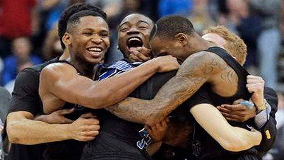 Georgia State players celebrate as they surround R.J. Hunter, center, after he made the game winning shot against Baylor an NCAA tournament second round college basketball game, Thursday, March 19, 2015, in Jacksonville, Fla. Georgia State won 57-56.