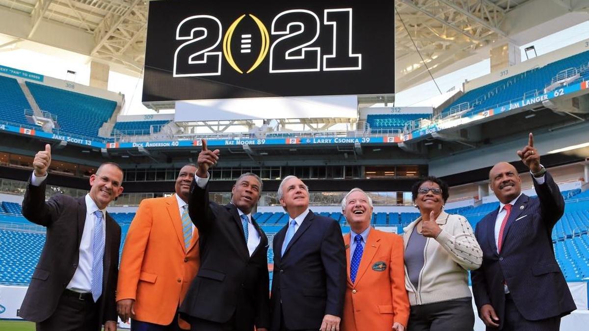 Miami-South Florida has been announced as the site for the 2021 College Football Playoff National Championship at Hard Rock Stadium on Wed., Nov. 1, 2017. Left to right are Eric Poms, Orange Bowl Committee Chair and CEO: Sean Pittman, President and Chair Elect of the Orange Bowl Commitee; Nat Moore, Senior Vice President, Special Projects and Alumni Relations for the Miami Dolphins: Miami-Dade Mayor Carlos Gimenez; Don Slesnick, President and Chair of the Orange Bowl Committee; Miami-Dade Commissioner Barbara Jordan and Michael Chavies, Chairman of the 2021 College Football Playoff Bid Committee.