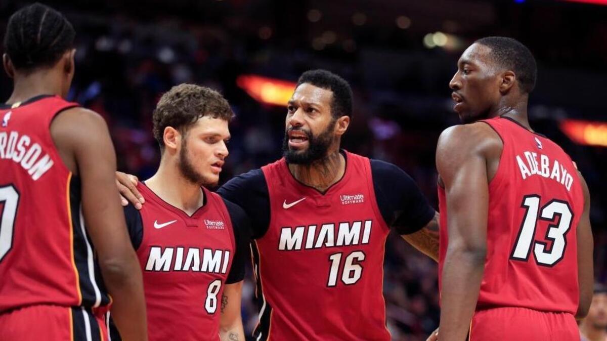Miami Heat forward Josh Richardson (0), guard Tyler Johnson (8), forward James Johnson (16) and center Bam Adebayo (13) gather on the court in overtime as the Miami Heat host the New York Knicks at AmericanAirlines Arena on Friday, January 5, 2018.