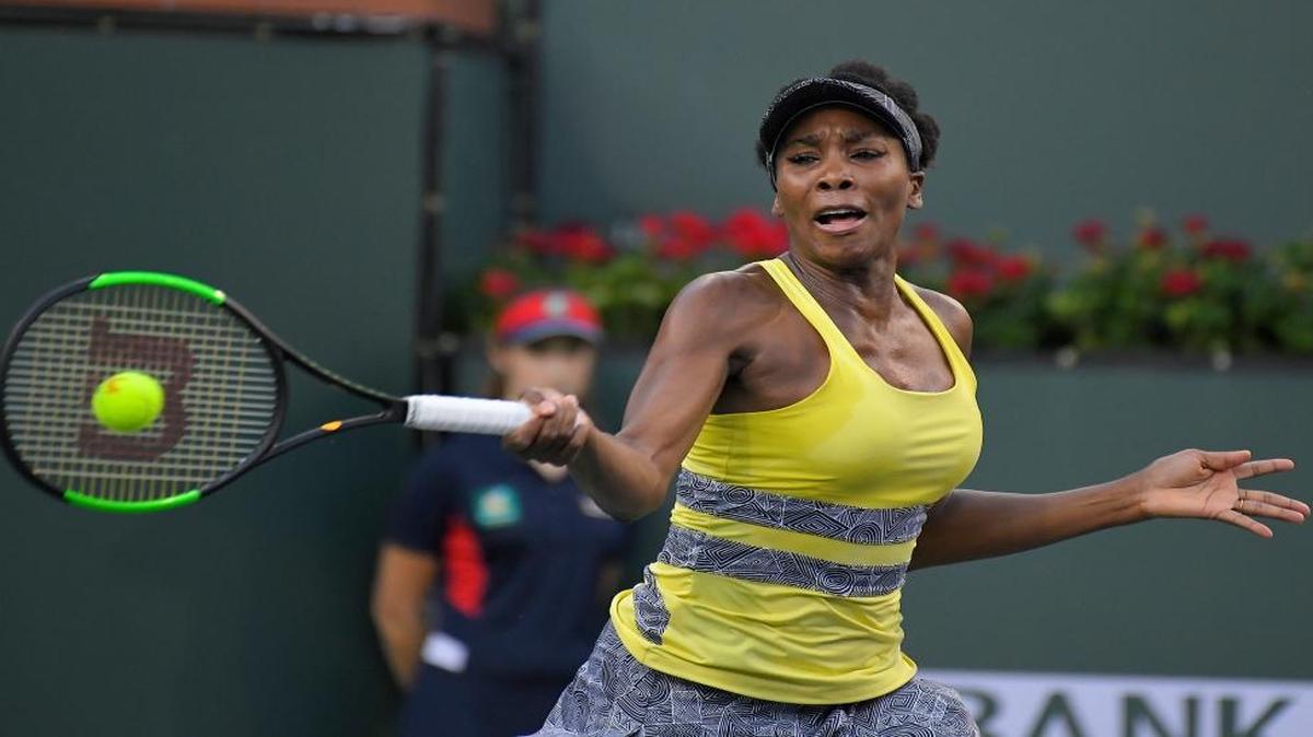 Venus Williams returns a shot to Elena Vesnina, of Russia, at the BNP Paribas Open tennis tournament, Thurs., March 16, 2017, in Indian Wells, Calif.