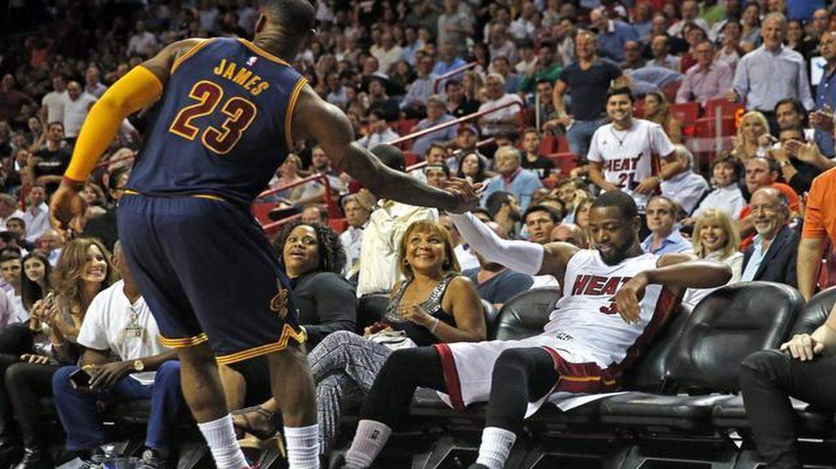 
 LeBron James helps Dwyane Wade up in the third quarter of the Miami Heat’s game against the Cleveland Cavaliers at AmericanAirlines Arena in Miami on March 16, 2015.
