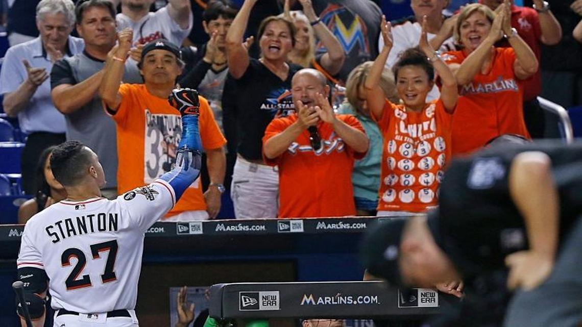 Giancarlo Stanton, center, gets a standing ovation from some fans after striking out at the bottom of the 9th inning. The Miami Marlins played its last game of the season against the Atlanta Braves as Stanton attempted to tie Babe Ruth's season home run record on Sunday, Oct. 1, 2017.