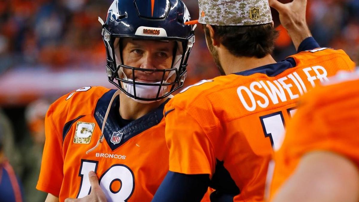 A dejected Denver Broncos quarterback Peyton Manning, left, looks to backup QB Brock Osweiler after being benched against the Kansas City Chiefs, Sunday, Nov. 15, 2015, in Denver.