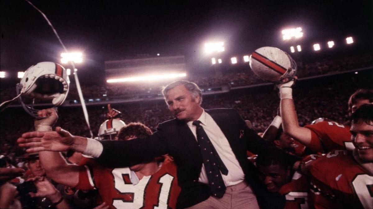 Coach Howard Schnellenberger gets a ride on his players’ shoulders after UM won the 1983 national championship.