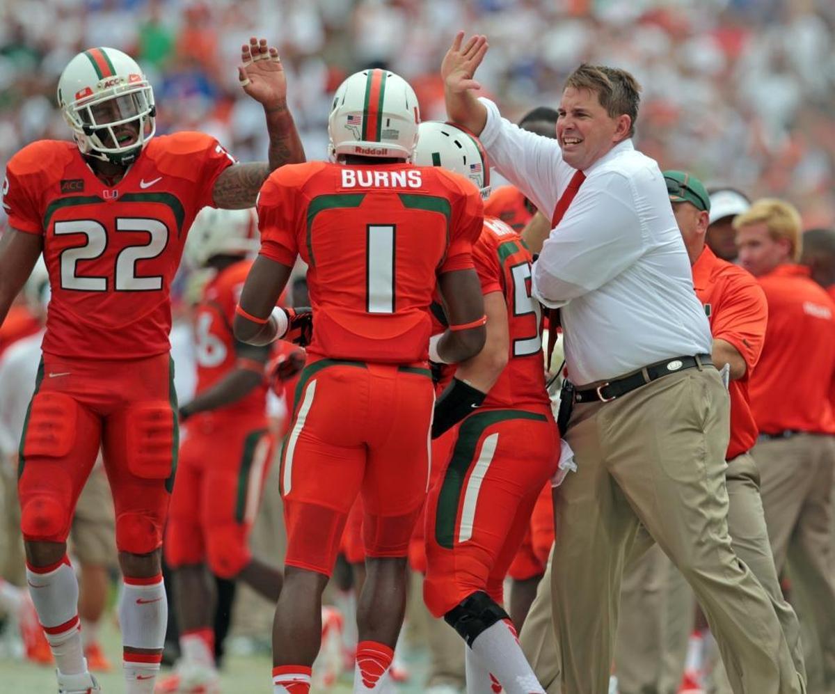 Miami head coach Al Golden celebrates with players in the second quarter during the University of Miami Hurricanes football game against the University of Florida Gators at Sun Life Stadium in Miami Gardens on Sat., Sept. 7, 2013.
