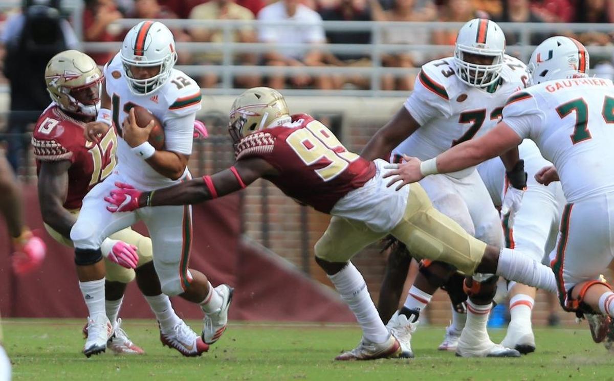 Miami Hurricanes quarterback Malik Rosier (12) runs for yardage in the first half as the Seminoles host the Miami Hurricanes at Doak Campbell Stadium in Tallahassee on Sat., Oct. 7, 2017.