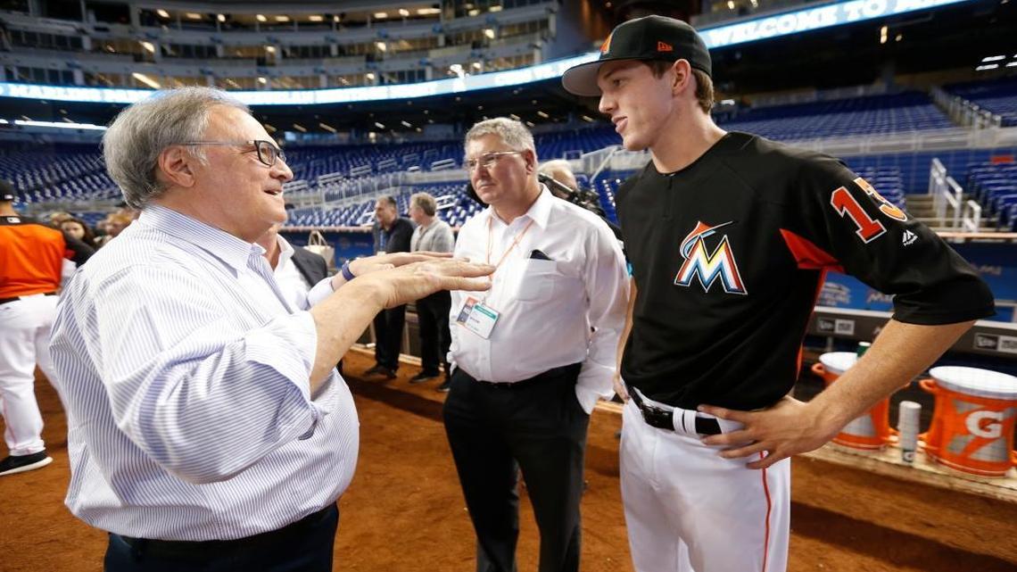 Then-Miami Marlins owner Jeffrey Loria, left, talks with Marlins' top draft pick Trevor Rogers, right, and his father Mike Rogers before a news conference last June after the Marlins signed the 13th overall draft pick to a deal that included a $3.4 million signing bonus. Rogers made this minor-league debut this week.