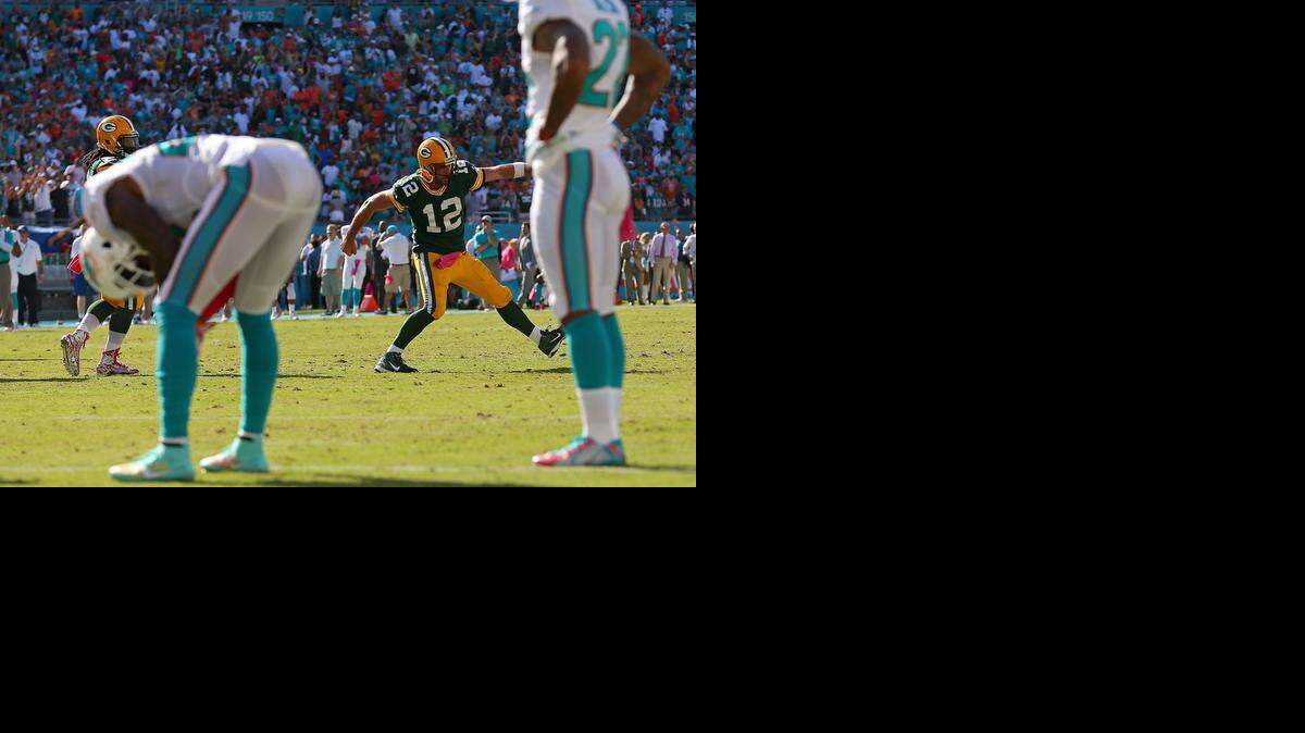 
Green Bay Packers quarterback Aaron Rodgers (12) celebrates the winning touchdown during a game against the Miami Dolphins at Sun Life Stadium in Miami Gardens on Oct. 12, 2014.
