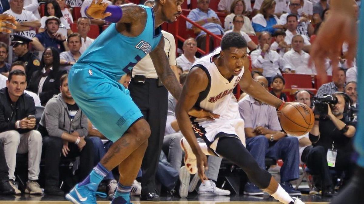 Josh Richardson, right, blows pass Hornets Marvin Williams, left, as he drives towards the basket on Sun., April 17, 2016 in the Heat’s game against the Charlotte Hornets in the first round of the NBA playoffs inside the American Airlines Arena in Miami, Florida.