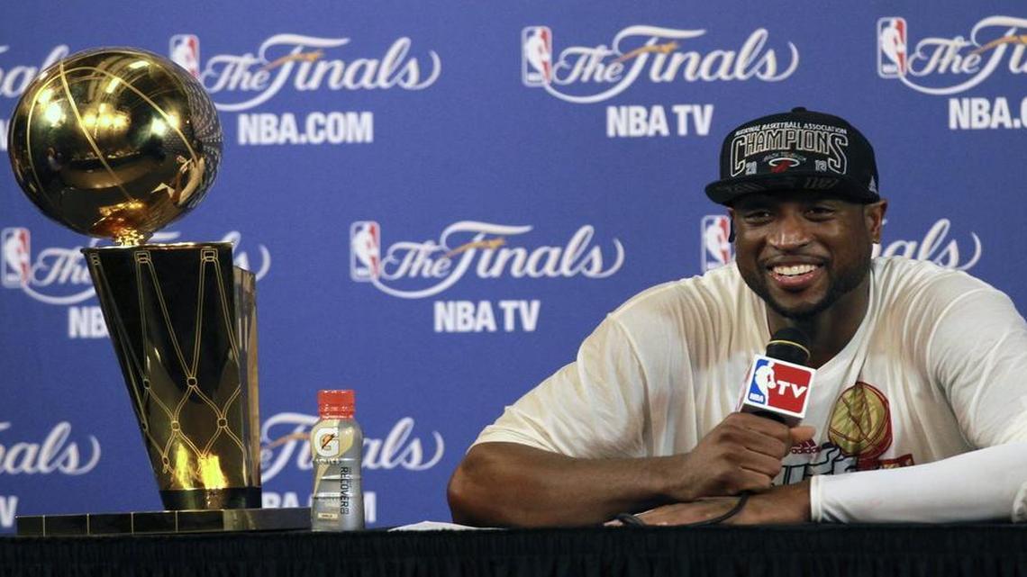 Sitting next to the Larry O’Brien trophy, Dwyane Wade answers questions after the Heat defeated the Spurs in Game 7 of the 2013 NBA Finals at AmericanAirlines Arena.