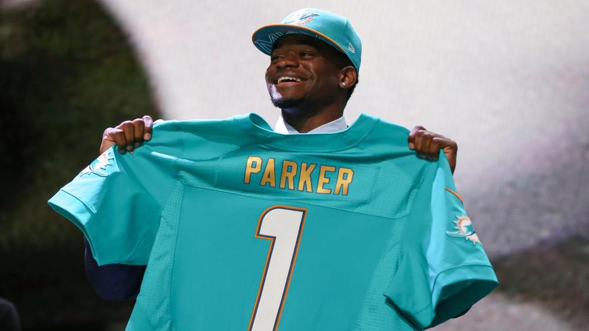 
DeVante Parker of the Louisville Cardinals holds up a jersey after being picked #14 overall by the Miami Dolphins during the first round of the 2015 NFL Draft at the Auditorium Theatre of Roosevelt University on April 30, 2015 in Chicago, Illinois. 
