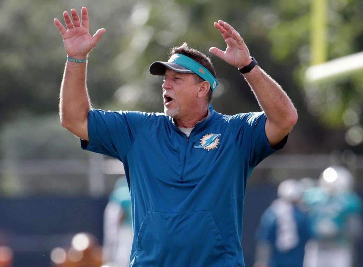 FILE - In this Aug. 16, 2016, file photo, Miami Dolphins offensive line coach Chris Foerster watches as players do drills during practice at NFL football training camp in Davie, Fla. The NFL and the Miami Dolphins say they're aware of a social media video allegedly showing offensive line coach Chris Foerster snorting a white powdery substance. NFL spokesman Brian McCarthy said Monday, Oct. 9, 2017, the league will review the 56-second video, which was posted on Facebook and Twitter.