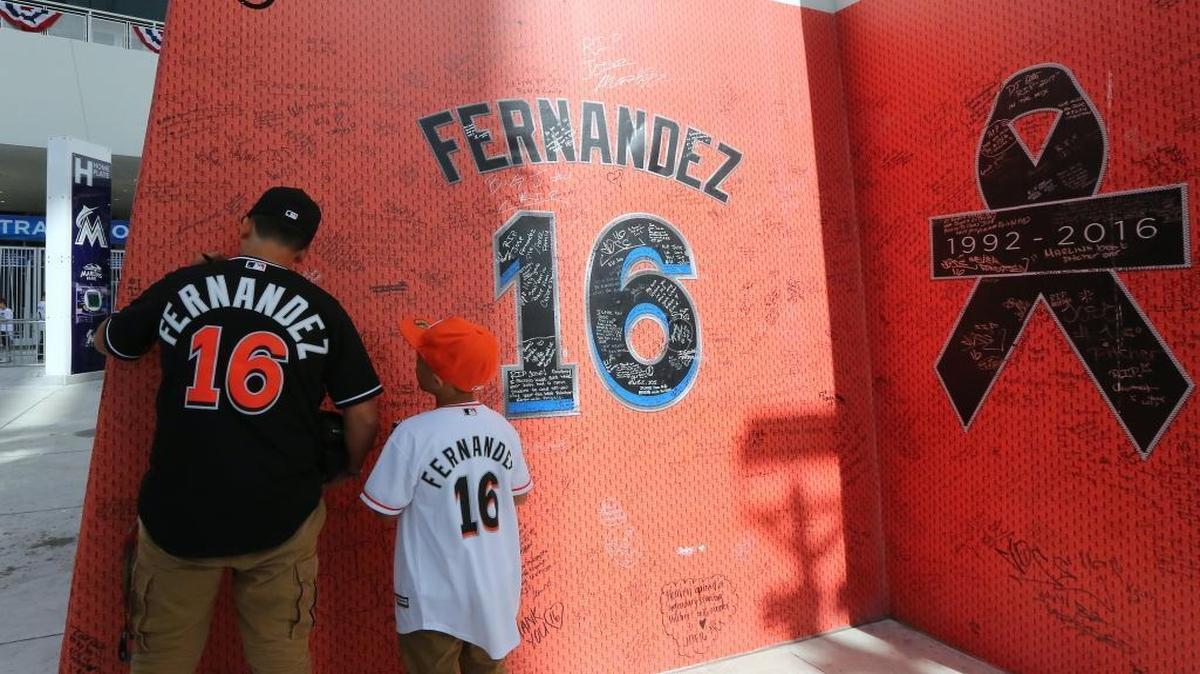 Dominic Estevez, left, and his brother Armani Estevez look at the Jose Fernandez tribute before the start of the Miami Marlins’ home opener against the Atlanta Braves at Marlins Park on Tuesday, April 11, 2017.