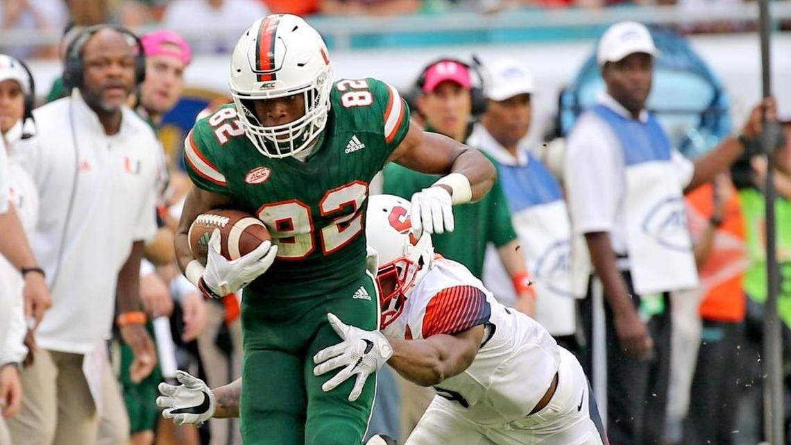 Miami Hurricanes Ahmmon Richards (82) catches a second quarter pass as Syracuse University Christopher Fredrick (3) tackles him at Hard Rock Stadium in Miami Gardens, Florida, Oct. 21, 2017.