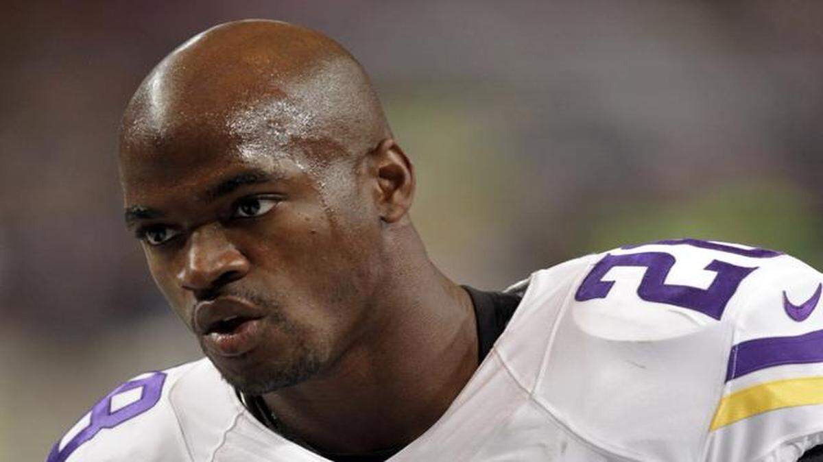 
FILE - In this Sept. 7, 2014, file photo, Minnesota Vikings running back Adrian Peterson warms up for an NFL football game against the St. Louis Rams in St. Louis. 
