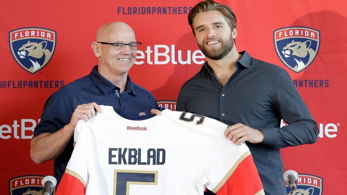 Panthers general manager Tom Rowe poses with Aaron Ekblad, who signed an eight-year extension Thursday. Ekblad could make the Panthers the premier team in South Florida.