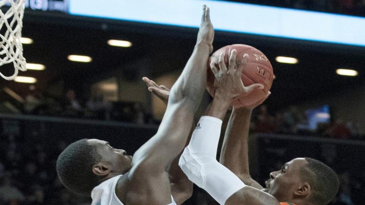 Miami guard Ja'Quan Newton (0) goes to the basket against North Carolina forward Theo Pinson (1) during the first half of an NCAA college basketball game in the Atlantic Coast Conference tournament, Thursday, March 9, 2017, in New York.