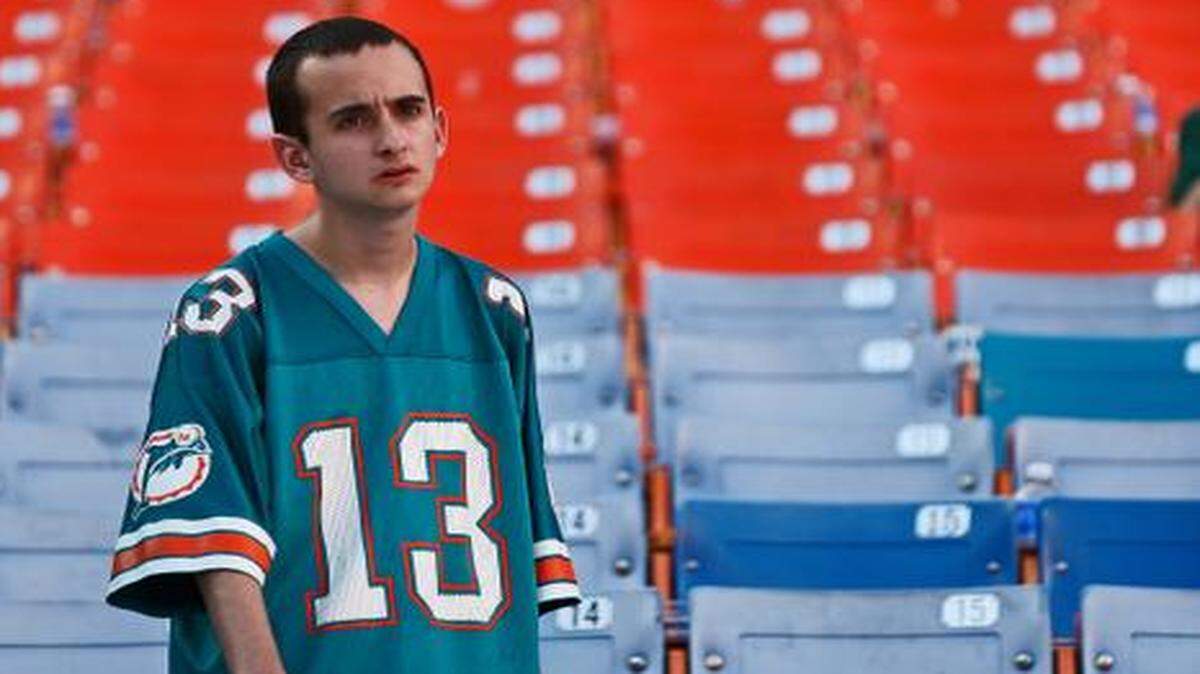 
Nostalgic about the past, a Miami Dolphins fans watches the team leave the field after losing to the New York Jets at Sun Life Stadium on Sunday, Dec. 28, 2014.
