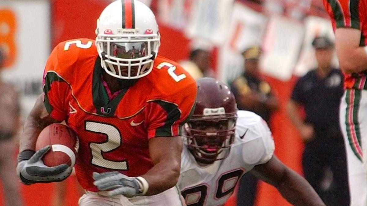 Miami Hurricanes running back Willis McGahee (2) slides past Virginia Tech defensive end Cols Colas (99) as he begins his run to the end zone for his record breaking sixth touchdown of the game Sat., Dec. 7, 2002 in Miami.