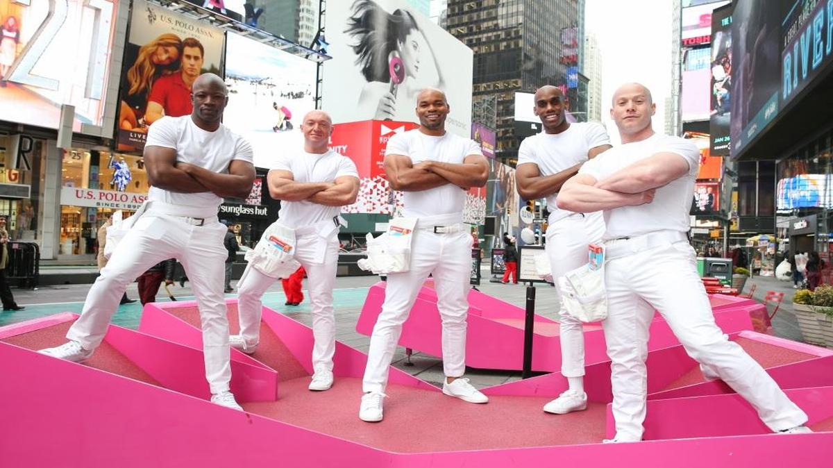 Mr. C's Sexy Dream Team and #TheNextMrClean Mike Jackson, center, clean up Times Square to celebrate the debut of Mr. Clean's Super Bowl ad on Thurs., Jan. 26, 2017 in New York.