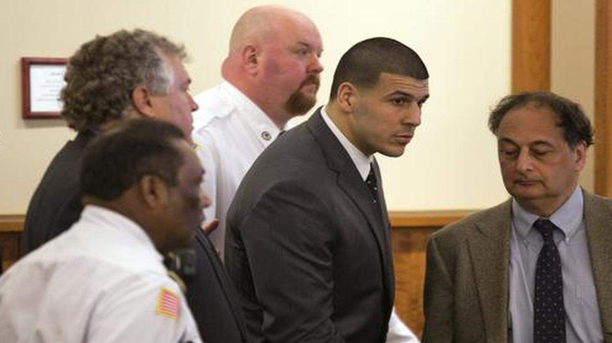 
Former New England Patriots football player Aaron Hernandez stands up after he is sentenced to life in prison at his murder trial at the Bristol County Superior Court in Fall River, Mass., on Wednesday, April 15, 2015. 
