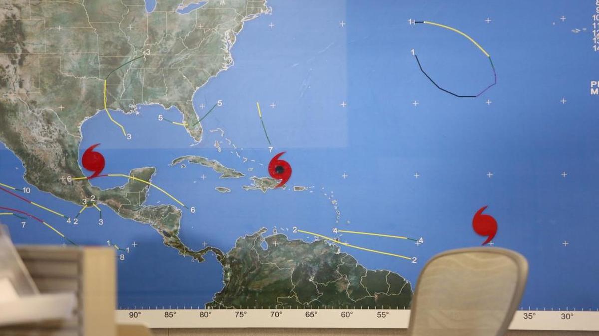 A map on the wall at the National Hurricane Center on Thursday afternoon, Sept. 7 2017, shows three current hurricanes on the map, Katia, Irma and Jose.