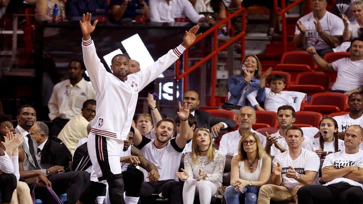 Dwayne Wade lifts his hands in the air after starters sit on the bench and a fresh squad scores late in the fourth quarter.The Miami Heat played against the Charlotte Hornets in Round 1 of the Eastern Conference playoffs on Sunday April 17, 2016.