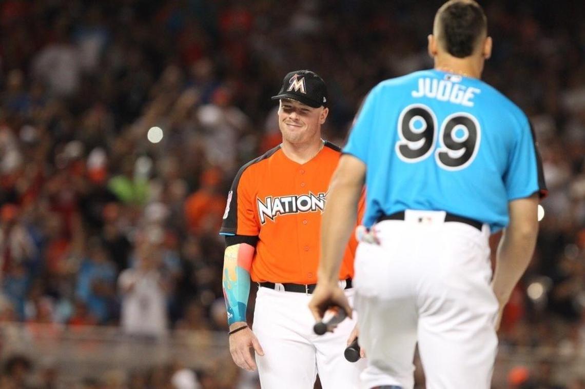 National League's Justin Bour, of the Miami Marlins, reacts as American League Aaron Judge of the New York Yankees walks during the MLB baseball All-Star Home Run Derby, Mon., July 10, 2017, at Marlins Park in Miami.