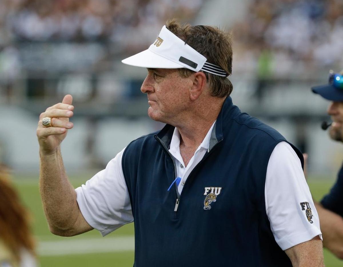 Florida International coach Butch Davis motions to players on the field during the first half of an NCAA college football game against Central Florida, Thurs., Aug. 31, 2017, in Orlando, Fla.