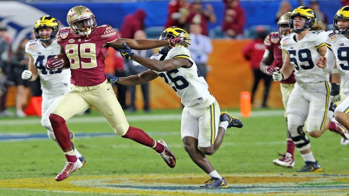 Florida State Seminoles Keith Gavin breaks away from Michigan Wolverines Jordan Lewis as Gavin help set-up the winning touchdown in the fourth quarter in the 2016 Capital One Orange Bowl at Hard Rock Stadium in Miami Gardens, Florida on Fri., Dec. 30, 2016.