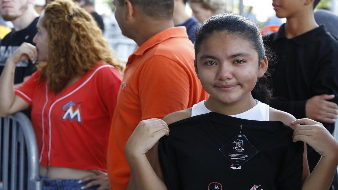 Jose Fernandez fan, Kelsi Figueroa, 12, fights back tears upon hearing of her sports hero's death. Kelis brought her Fernandez shirt to the game prior to its cancellation as she waited with others to receive commemorative bats. Miami Marlins star pitcher, Jose Fernandez, who died last night during a boating accident, is remembered with his number displayed outside Marlins Park.