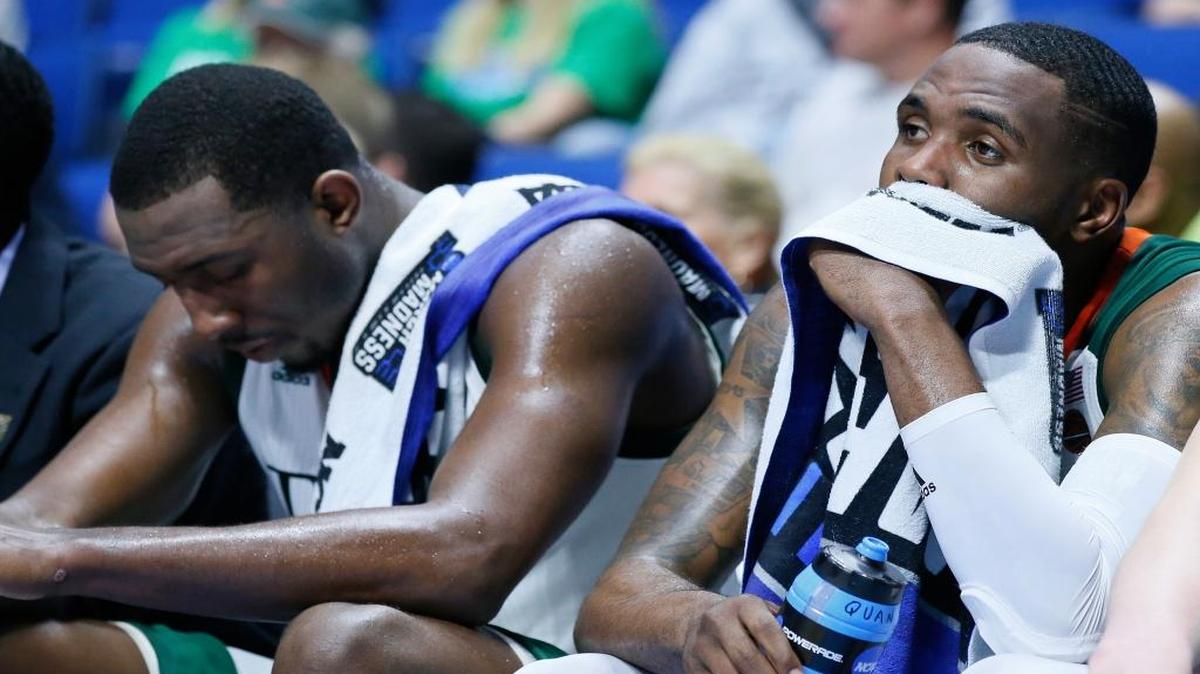 Miami's Ja'Quan Newton, right, and Davon Reed, left, sit on the bench late in the second half of a first-round game against Michigan State in the men's NCAA college basketball tournament in Tulsa, Okla., Friday, March 17, 2017. Michigan State won 78-58.