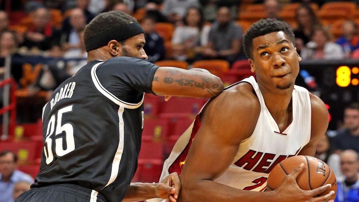 Miami Heat center Hassan Whiteside gets pushed in the back by Brooklyn Nets forward Trevor Booker in the first quarter of their game at the AmericanAirlines Arena in Miami on Jan. 30, 2017.
